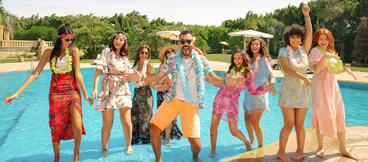 Summer campaign photoshoot of a group posing in a swimming pool